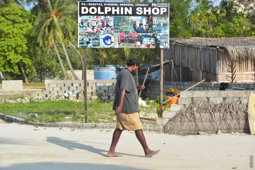 ޒުވާނަކު އިލޮށި ފައްޗެއް ހިފައިން ހިގާފައި ދަނީ: ހިންމަފުއްޓަކީ މަސައްކަތްތެރި ޒުވާނުންތަކެއް އުޅޭ ރަށެކެ--- ސަން ފޮޓޯ/ މުހައްމަދު އަފްރާހް