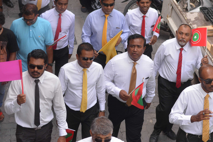 ޖުލައި 26، 2018: އިދިކޮޅު ރިޔާސީ ކެންޑިޑޭޓު އިބްރާހިމް މުހައްމަދު ސޯލިހު (އިބޫ) ގެ ކެންޑިޑެންސީ ފޯމު ހުށަހެޅުއްވުމަށް އިލެކްޝަންސް އަށް ވަޑައިގަންނަވަނީ: ގިނަ އަދަދެއްގެ ބަޔަކު އިބޫއާ އެކު އެމްޑީޕީ އޮފީހުން ފެށިގެން އިލެކްޝަންސް ކޮމިޝަނުގެ އިދާރާއަށް ގޮސްފައިވަނީ ބެރު ޖަހަމުން ހިނގާފައި  --- ސަންފޮޓޯ/ މުހައްމަދު އަފްރާހް