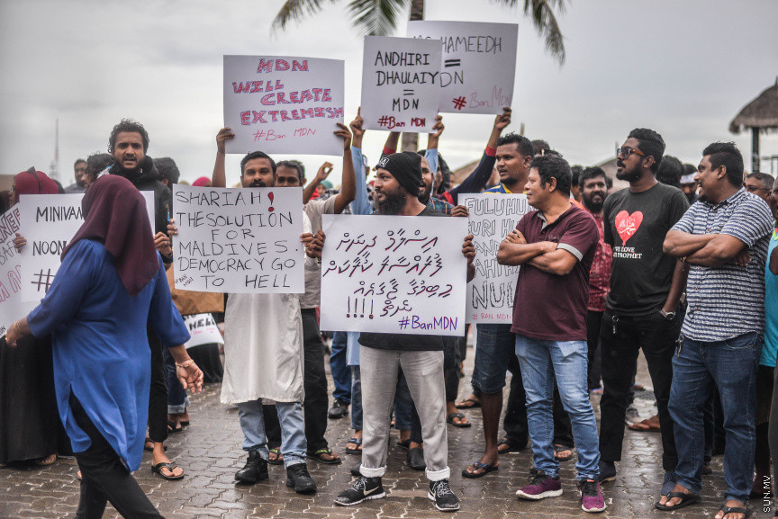 އޮކްޓޫބަރ 25، 2019: އިސްލާމް ދީނާ ހިލާފު ވާހަކަތަކެއް ހިމަނައި، ރިޕޯޓުު ނެރުނު މޯލްޑިވިއަން ޑިމޮކްރެސީ ނެޓްވޯކް (އެމްޑީއެން) އުވާލުމަށް ގޮވާލާ މާލޭގައި ކުރި މުޒާހިރާގެ ތެރެއިން -- ސަން ފޮޓޯ/ ފަޔާޒު މޫސާ
